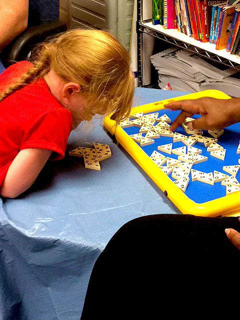 A child playing with a tactile game.